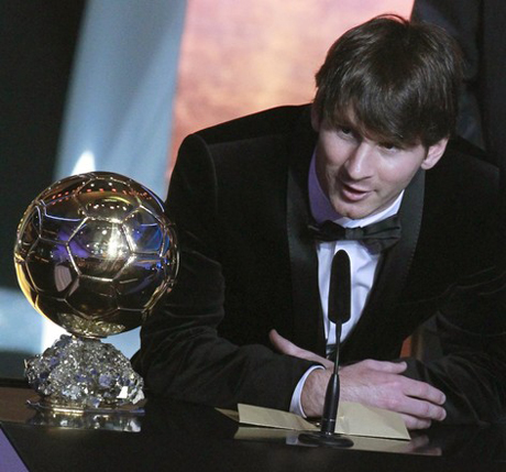 Messi of Argentina FIFA World Player 2010 stands nexthis trophy during the FIFA Ballon d'Or 2010 soccer awards ceremony in Zurich